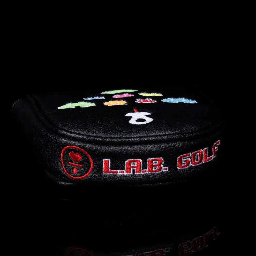 Side profile of LAB Golf Player One Headcover with L.A.B. Golf branding and pixelated alien invader embroidery.