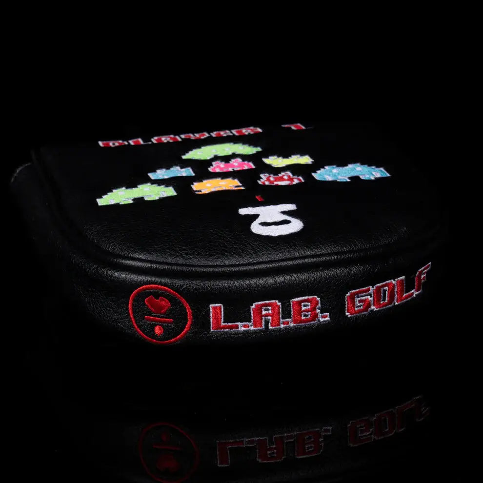 Close-up side view of LAB Golf Player One Headcover with stitched L.A.B. Golf logo and retro alien design.