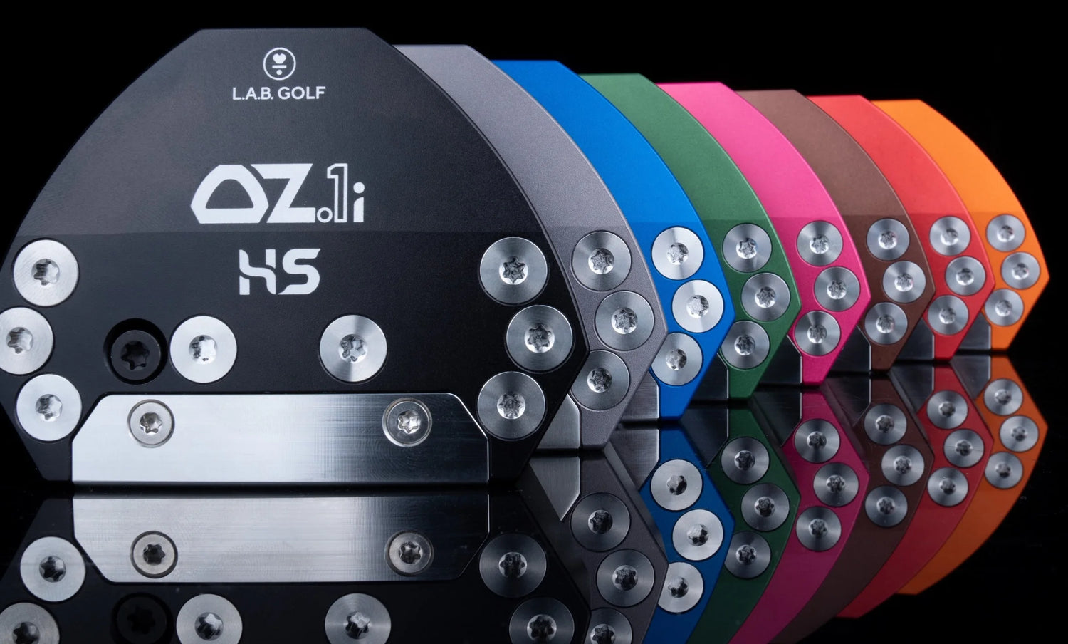 L.A.B. Golf OZ.1i HS golf club head in various colors on a reflective surface.